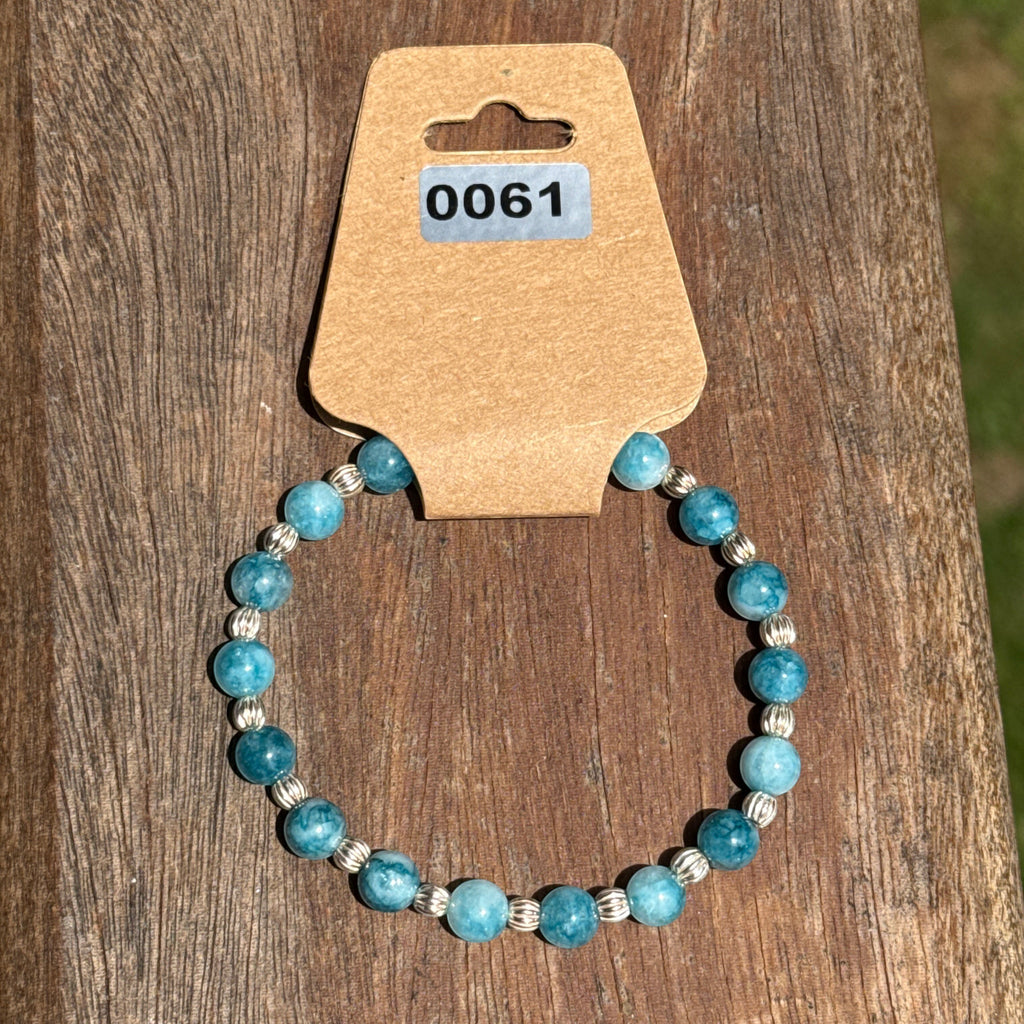 Bailey’s Bits & Baubles ocean blue Larimar and sterling silver pumpkin bead bracelet on a display card showing inventory number.