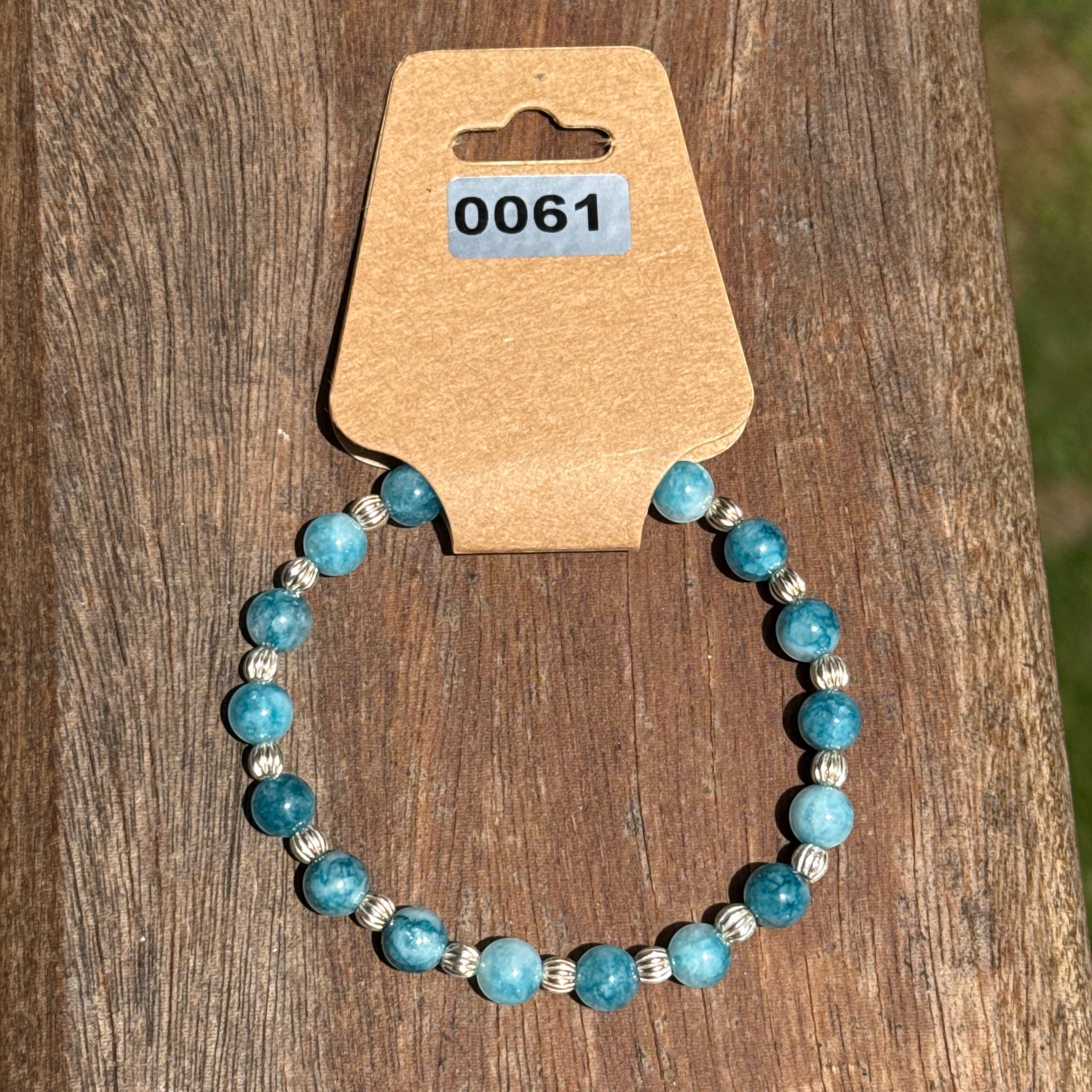 Bailey’s Bits & Baubles ocean blue Larimar and sterling silver pumpkin bead bracelet on a display card showing inventory number.