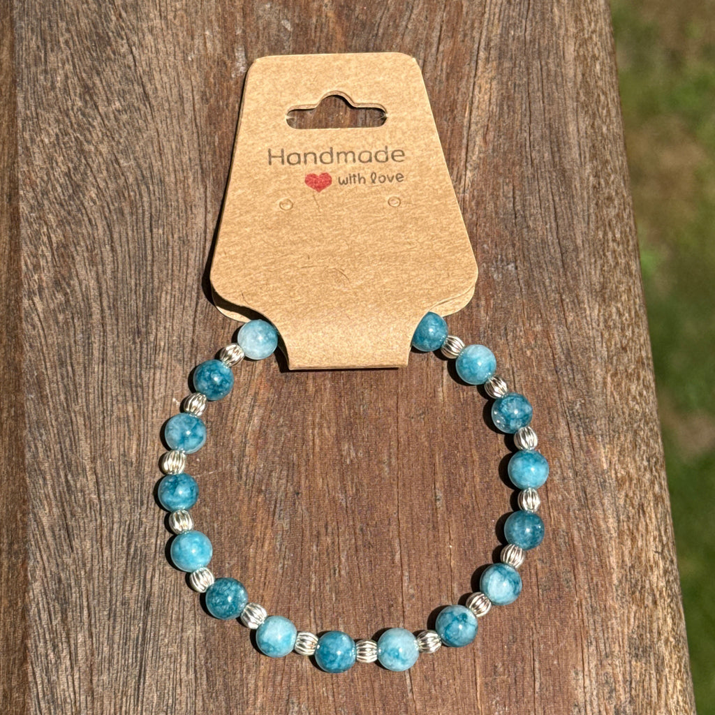 Bailey’s Bits & Baubles ocean blue Larimar and sterling silver pumpkin bead bracelet on a "Handmade with Love" display card.
