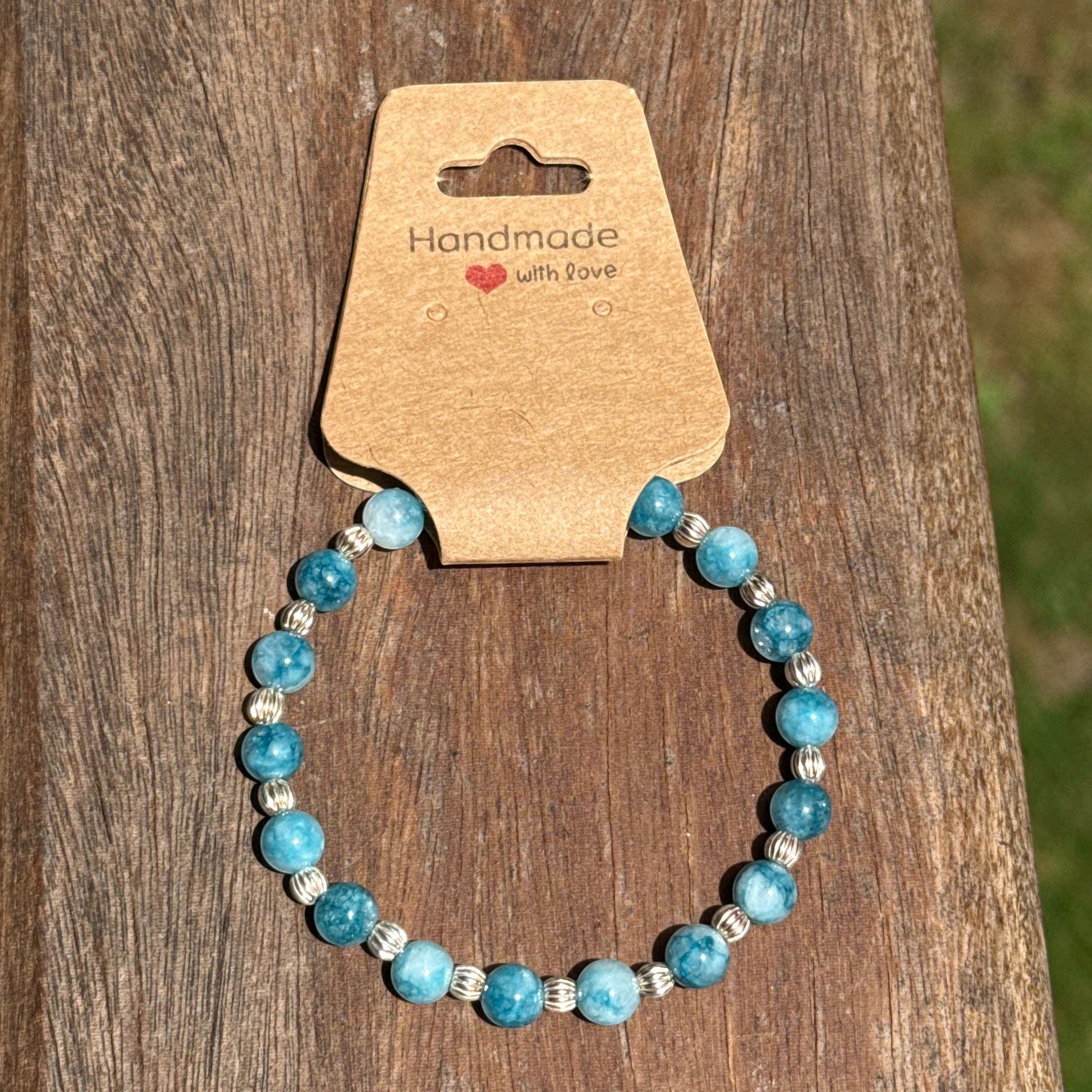 Bailey’s Bits & Baubles ocean blue Larimar and sterling silver pumpkin bead bracelet on a "Handmade with Love" display card.
