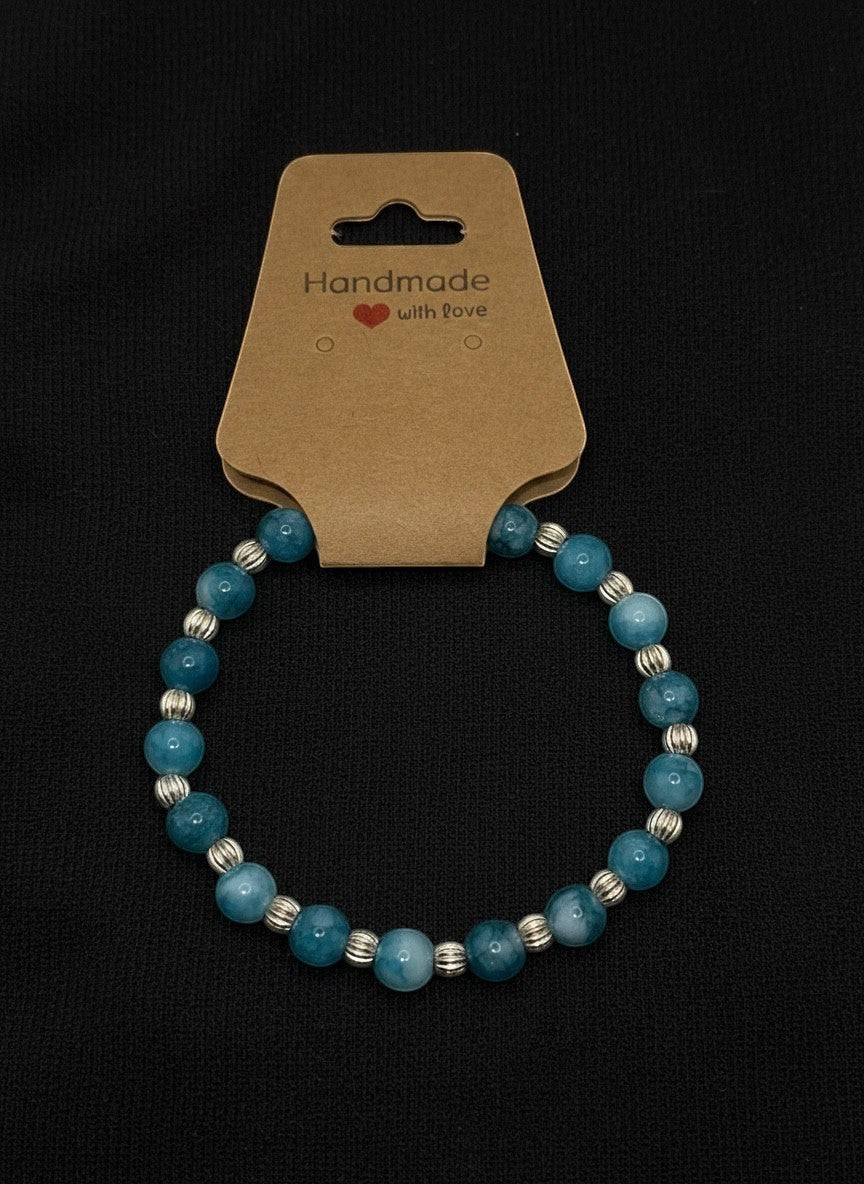 Bailey’s Bits & Baubles ocean blue Larimar and sterling silver pumpkin bead bracelet on a "Handmade with Love" display card.